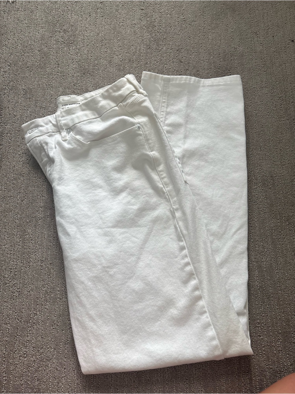Good American White Denim Jeans with Pink Accent Nails Visible